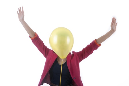 Businesswoman with face covered with balloon expressing happiness isolated on whiteの写真素材
