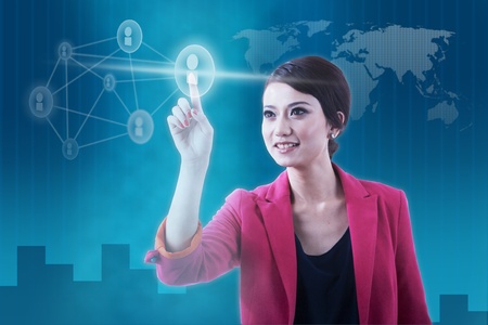 Businesswoman pressing social network icon over futuristic backgroundの写真素材