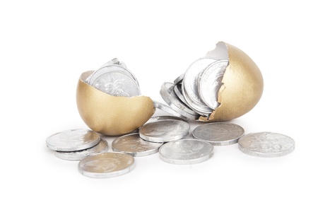 Broken golden eggs with coins on white background