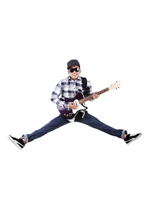 Guy plays guitar while jumping on white backgroundの写真素材