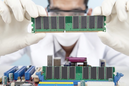 A scientist checking the memory card of motherboard