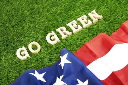 American flag on green graass with the word go green