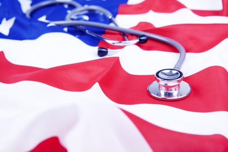 Photo of American flag and stethoscope  illustrating American healthcare issuesの写真素材
