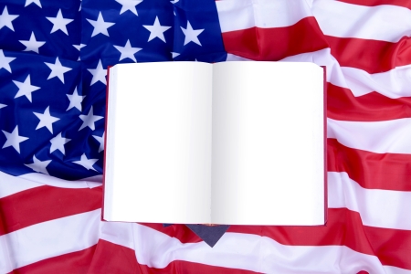 Open blank book on top of USA flag. Space can be used to add your own textの写真素材