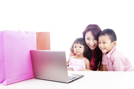 Happy asian family shopping online by using laptop computer, isolated on whiteの写真素材