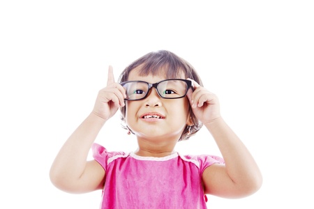 Portrait of asian female preschooler wearing glasses and rises her finger. shot in studio isolated on whiteの写真素材