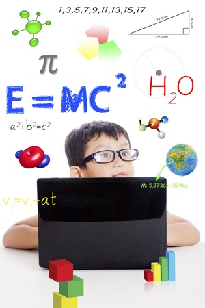 Portrait of smart boy with physics formula and laptop computerの写真素材