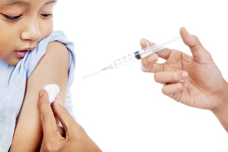 Little child have a vaccination shot in studio isolated on white の写真素材