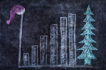 Chalk drawing of santa hat, bar chart and christmas tree on the blackboardの写真素材
