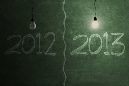 Bright future concept with bright light bulb on 2013 and light bulb is off on 2012の写真素材
