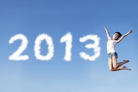 A female jumping to welcome the new year of 2013の写真素材