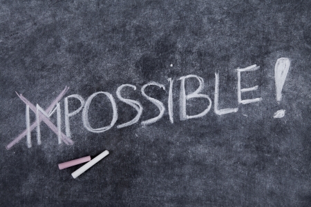 Text of impossible is nothing written on a blackboard