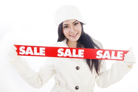Portrait of fashionable woman showing banner of winter sale. isolated on white backgroundの写真素材