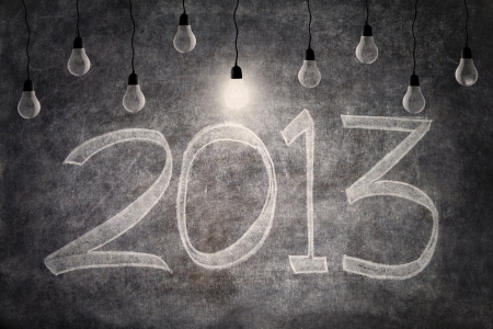 Bright ideas of 2013 represent by light bulbs on blackboard backgroundの写真素材