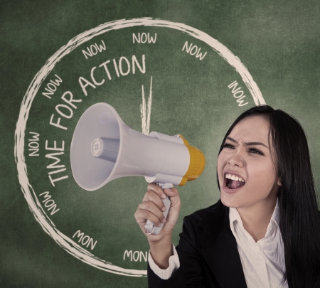 Young businesswoman announcing using speaker in classroomの写真素材