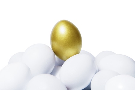 Golden egg standing out in the crowdsの写真素材