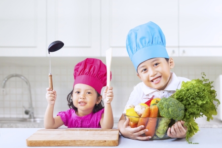 Cute little Asian chef with vegetablesの写真素材