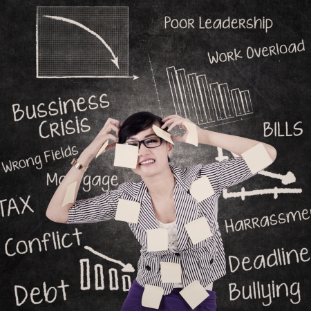 Businesswoman is stressing out due to problems and hectic schedulesの写真素材