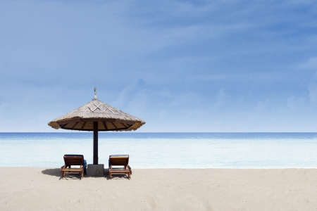 Beach hut on a beautiful tropical beach with clear water and blue skyの写真素材