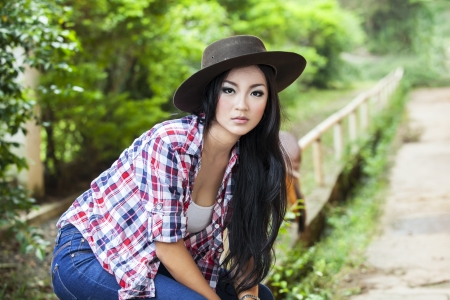 Attractive woman with cowboy hat at the farm ranchの写真素材
