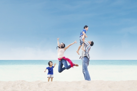 Asian family having fun at the beachの写真素材