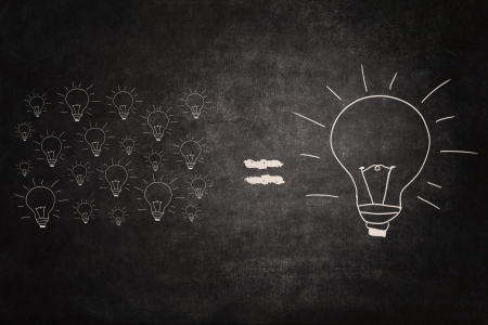 Picture of many small lightbulbs equal big lightbulbの写真素材