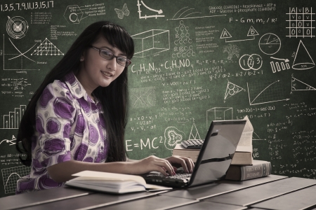 Female accountant with glasses typing on laptop in classの写真素材