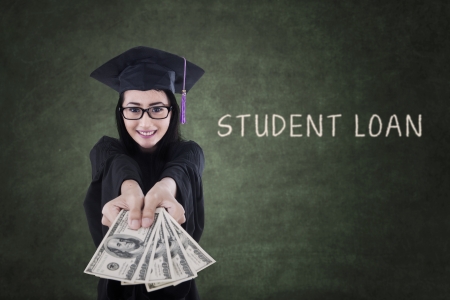 Young female graduate is getting money from student loanの写真素材