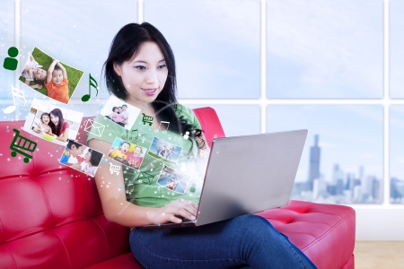 Pretty young female download online pictures and music at apartmentの写真素材