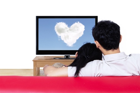 Couple watching love cloud on red sofa - isolated