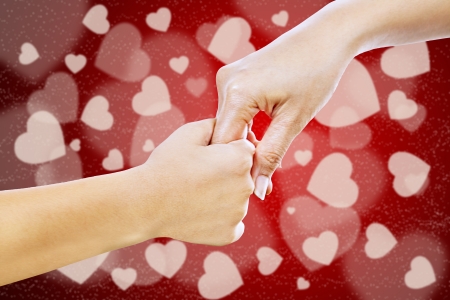 Mother giving her hand to her son on Valentine's dayの写真素材