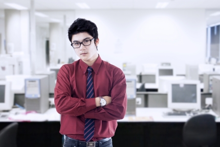 Portrait of young asian businessman in officeの写真素材
