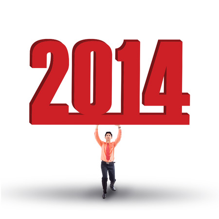 Portrait of businessman is lifting new year 2014