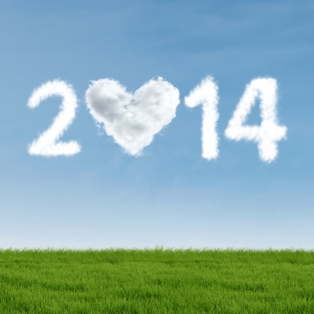 New year of 2014 with heart shaped cloud over green meadowの写真素材