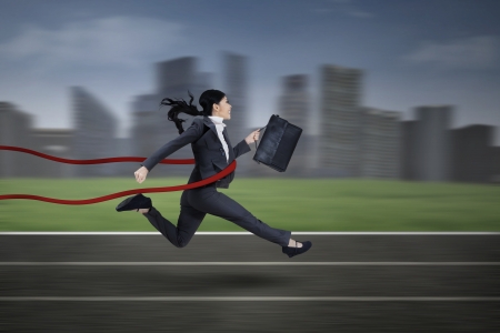 Asian businesswoman winning a race at business competitionの写真素材