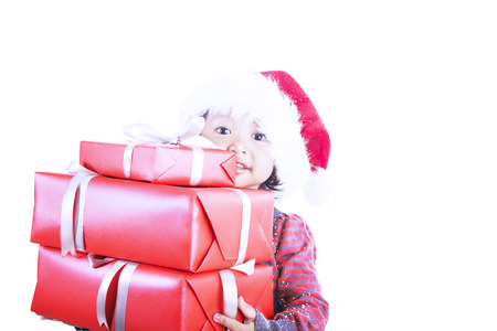 A girl carry christmas presents isolated in whiteのeditorial素材