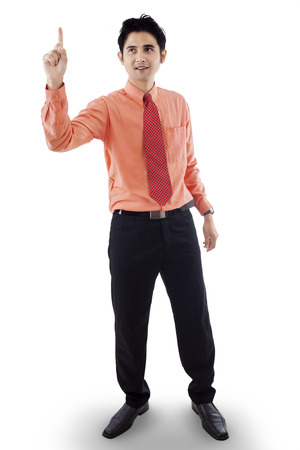 Portrait of attractive businessman getting an idea by pointing upwardsの写真素材
