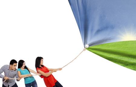 Group of three young friends are pulling big banner