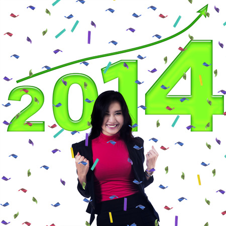 Successful young business woman celebrating a new year of 2014の写真素材