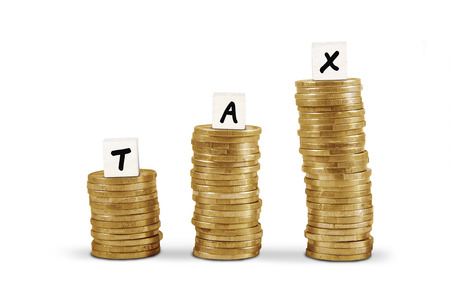 Word tax on gold coin stacks isolated on white backgroundの写真素材