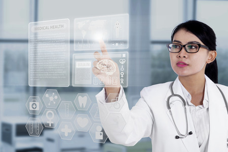 Female doctor touching medical interface with modern technologyの写真素材