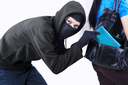 Thief stealing from handbag of a woman