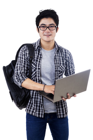 Young male student with laptop. isolated on white backgroundの写真素材