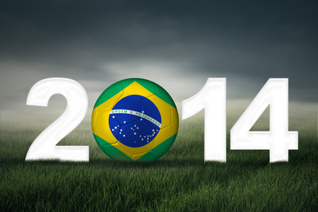 Soccer ball with brazilian flag on the field symbolizing soccer championship of 2014の写真素材