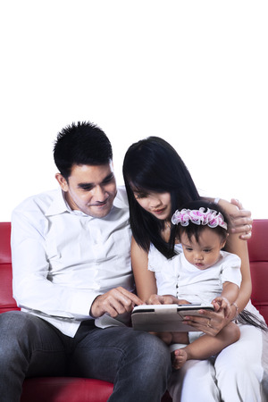 Happy family using a digital tablet. Isolated on white の写真素材