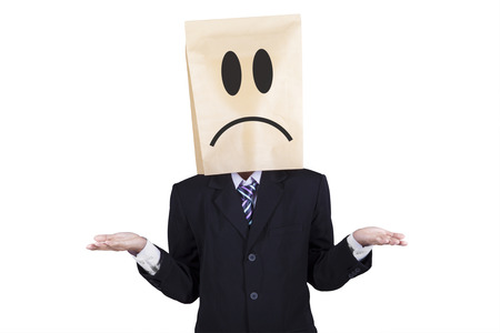 Confused businessman with paper head gesturing confuseの写真素材