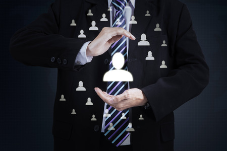 Businessman with protective gesture of his partnersの写真素材
