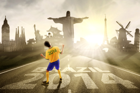 Portrait of soccer player heading ball symbolizing soccer competition started in brazilのeditorial素材