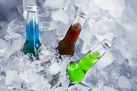 Closeup of bottles of beer sink on ice cubeの写真素材