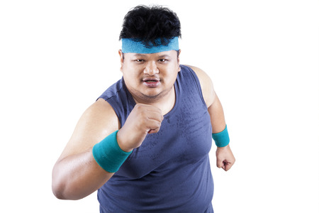 Fat man running for exercising. isolated on white backgroundの写真素材